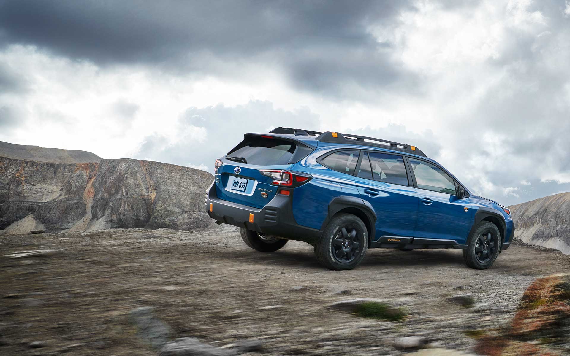 2022 Subaru Outback Wilderness driving down a rocky incline.